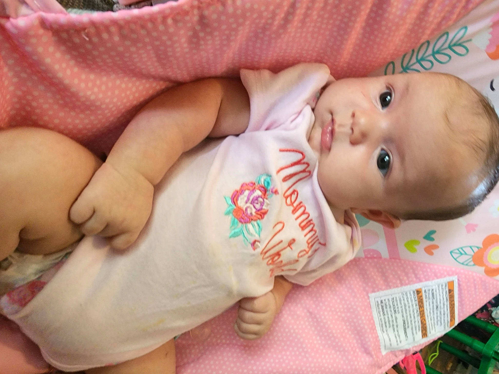 Anastasia is registered to the contest to win money with this photo: arm, baby, baby_toddler_clothing, cheek, chin, facial_expression, finger, gesture, hand, human_body, lip, mammal, mouth, nose, person, pink, skin, sleeve, textile, toddler