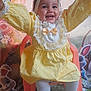 baby, child, yellow_dress, headband, bow, smiling, chair, white_tights, white_shoes, happy, indoor, decorations, cartoon_bunny, floral_background, celebration, cute, portrait, infant, joyful, playful