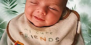 Ezio participe au concours pour gagner de l'argent avec cette photo : baby, infant, newborn, smile, sleepy, bib, toy, toy_clip, onesie, clothing, chubby_cheeks, face, head, portrait, close_up, green_leaf_background, leaf_pattern, soft_texture, indoor, cute