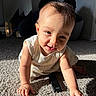 baby, child, crawling, carpet, remote_control, smiling, sunlight, indoor, person, infant, cute, playful, happy, young_child, face, arm, hand, clothing, floor, shadow