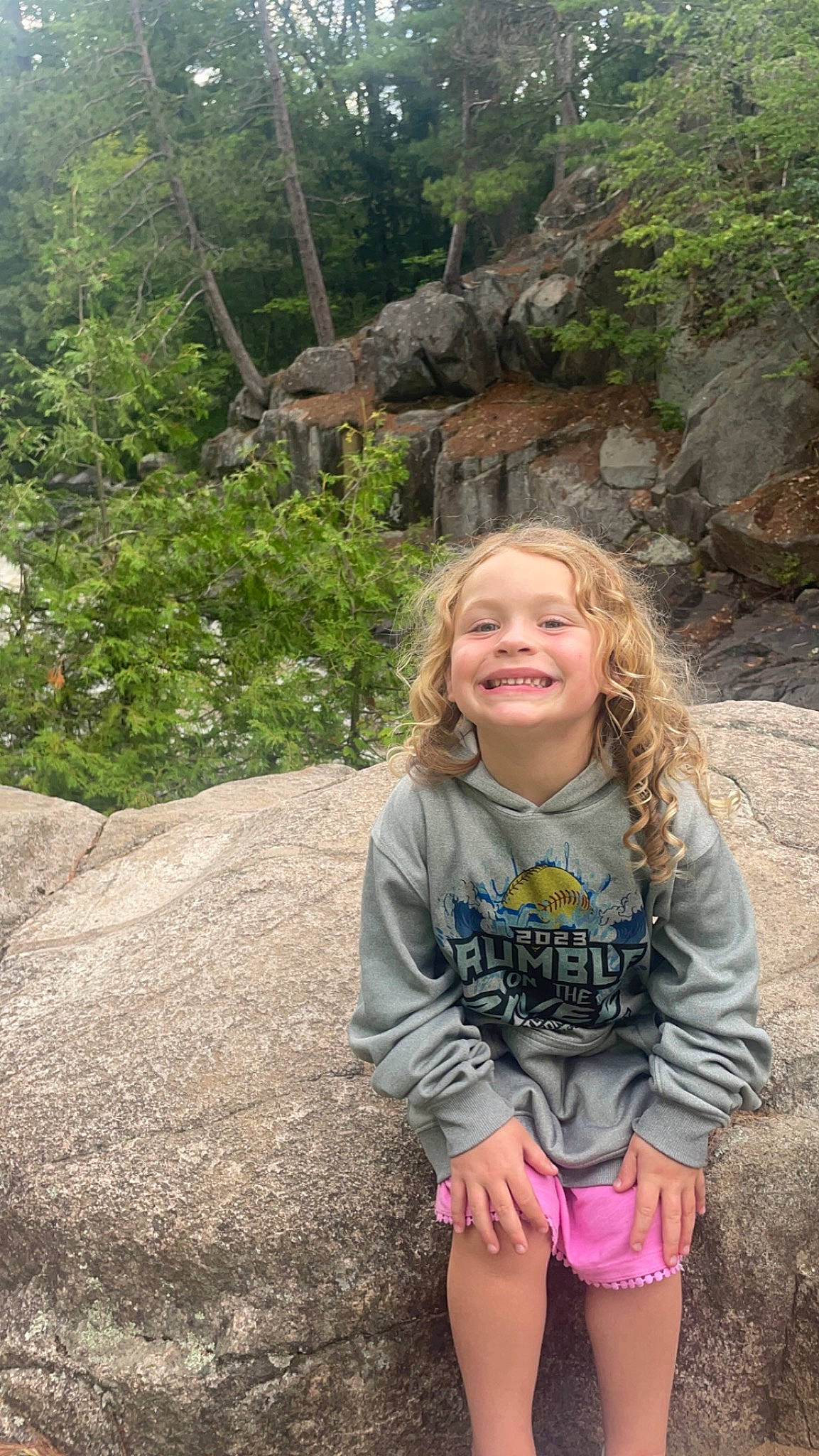 Vivian is registered to the contest to win money with this photo: bedrock, fawn, forest, formation, fun, grass, hair, happy, joy, landscape, leisure, natural_environment, nature, people_in_nature, person, plant, recreation, smile, travel, tree