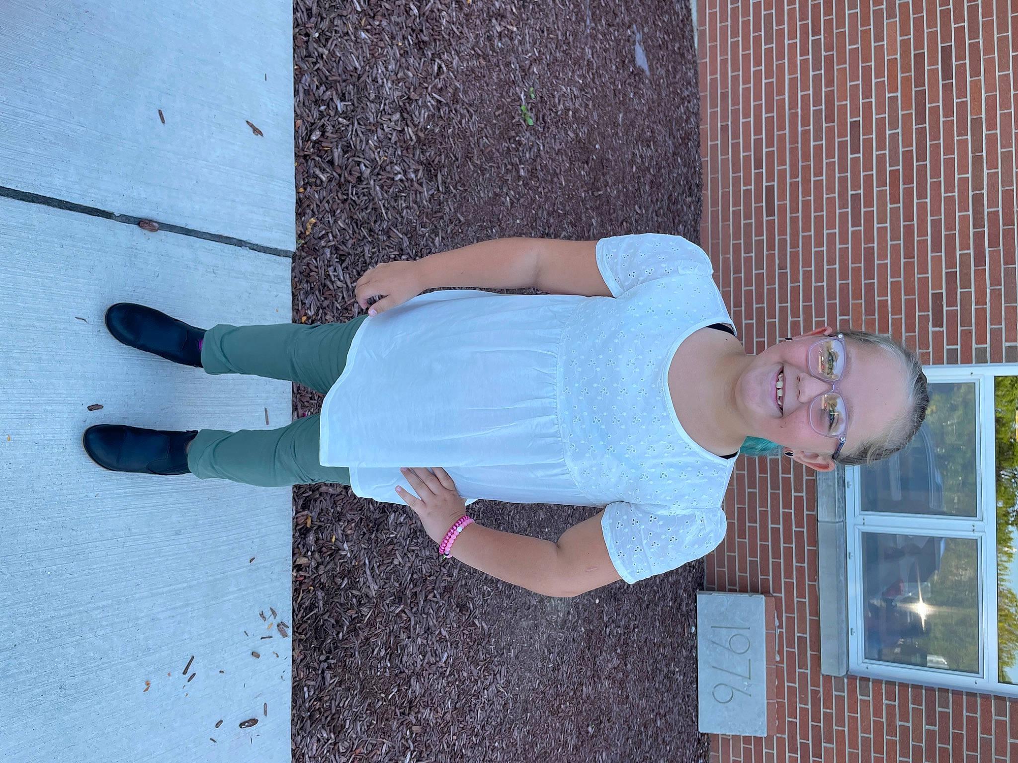 Charlotte is registered to the contest to win money with this photo: concrete, elbow, electric_blue, eyewear, fun, human_leg, joy, knee, leisure, pattern, person, smile, street_fashion, t_shirt, textile, thigh, waist, walking_shoe, wall, window