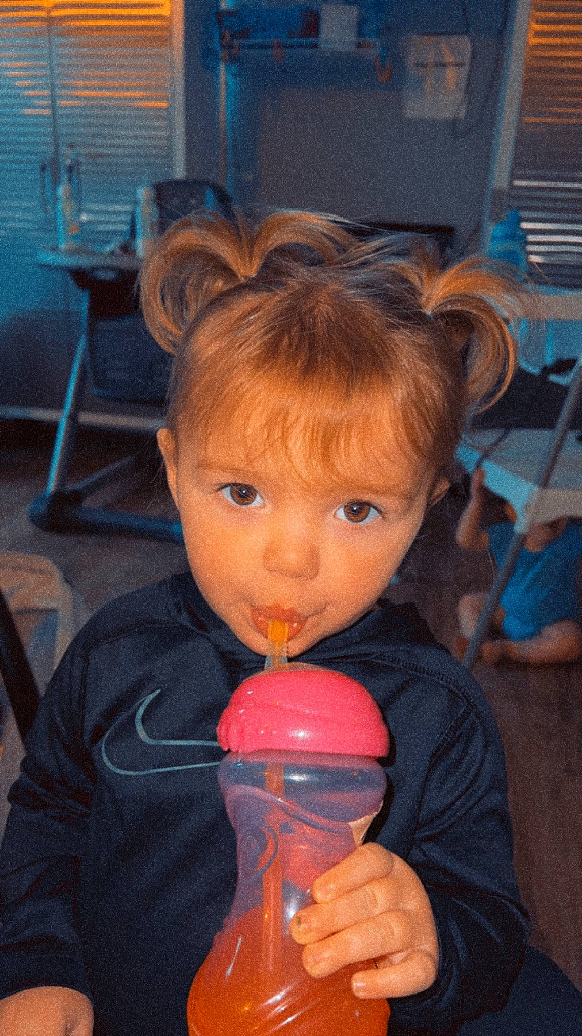 Raeleigh is registered to the contest to win money with this photo: blue, chair, cheek, child, drink, drinking, drinkware, finger, flooring, food, frozen_dessert, fun, ice_cream, nose, person, play, sitting, sweetness, television, thumb
