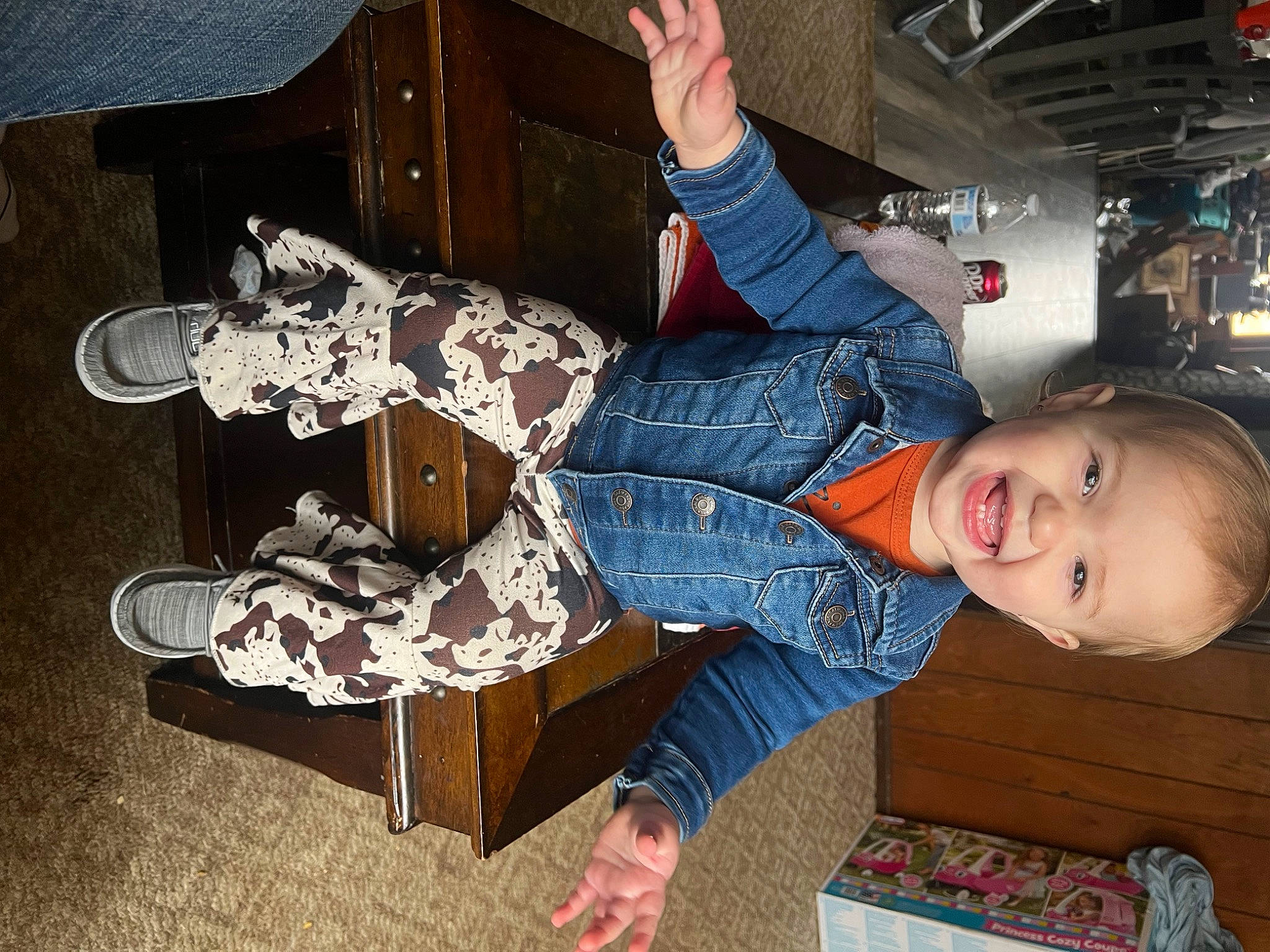 Raeleigh joined the competition — help win amazing prizes! baby_toddler_clothing, child, denim, fun, happy, human_leg, lap, leg, leisure, pattern, person, room, shoe, sitting, smile, sneakers, sock, thigh, toddler, wood
