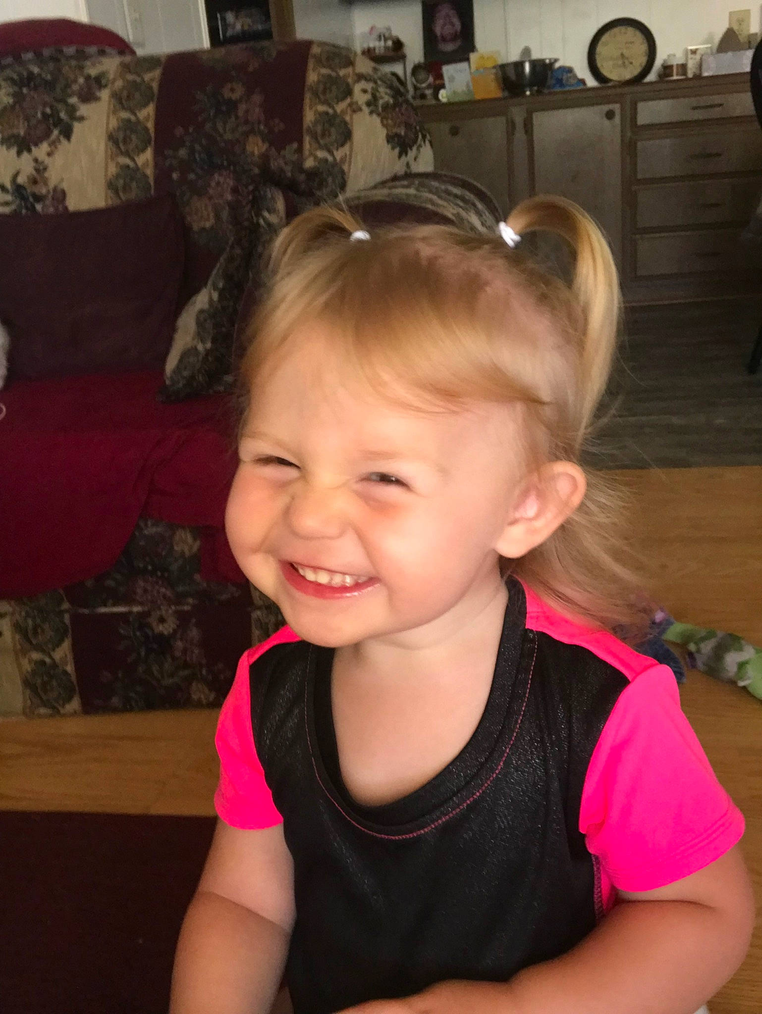 Talia is registered to the contest to win money with this photo: arm, cheek, child, chin, ear, face, forehead, fun, hair, hair_accessory, hairstyle, head, headband, joy, neck, person, pink, skin, smile, toddler