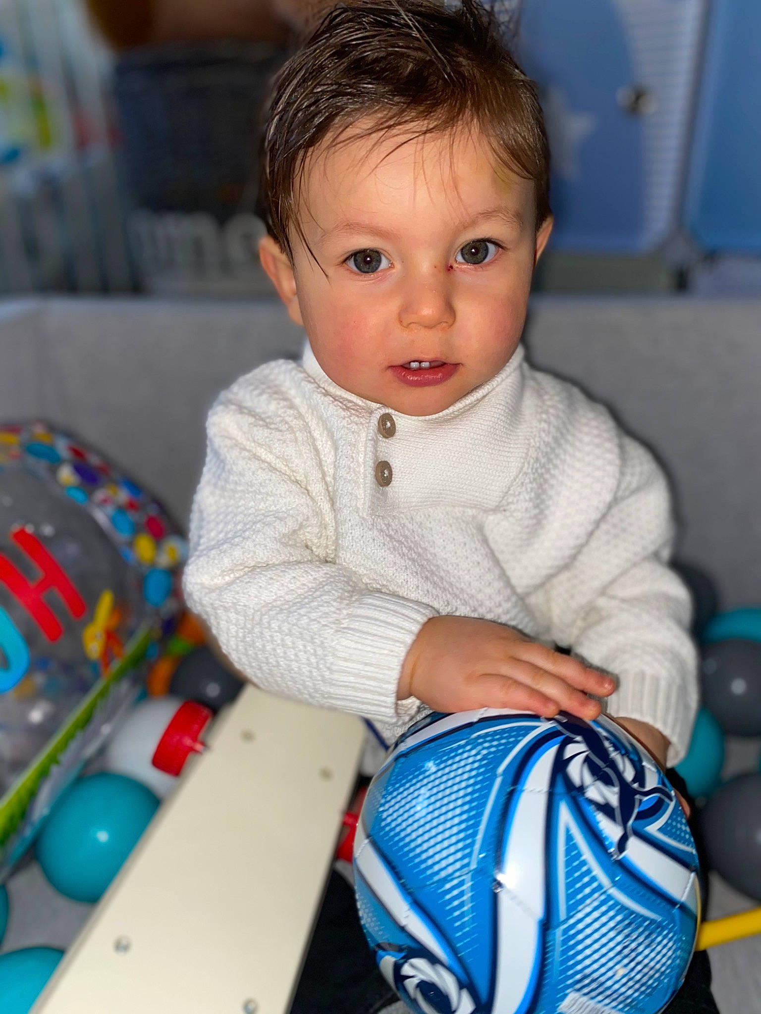 Dieydi participe au concours pour gagner de l'argent avec cette photo : baby, baby_playing_with_toys, baby_products, baby_toddler_clothing, baby_toys, ball, blue, cheek, child, electric_blue, face, fun, hair, head, person, play, product, room, sitting, toddler