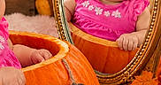 Aitana is registered to the contest to win money with this photo: baby, infant, child, portrait, pumpkin, autumn, fall, mirror, pink_bow, pink_dress, smiling, sitting, seasonal, indoor, photography, reflection, orange, leaves, cozy, five_months