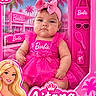 Aitana is registered to the contest to win money with this photo: baby, infant, child, portrait, face, pink, barbie, doll_packaging, toy_box, bow, dress, sparkly, fashion, sitting, front_facing, indoor, product_display, palm_trees, cartoon_character, smartphone_screenshot