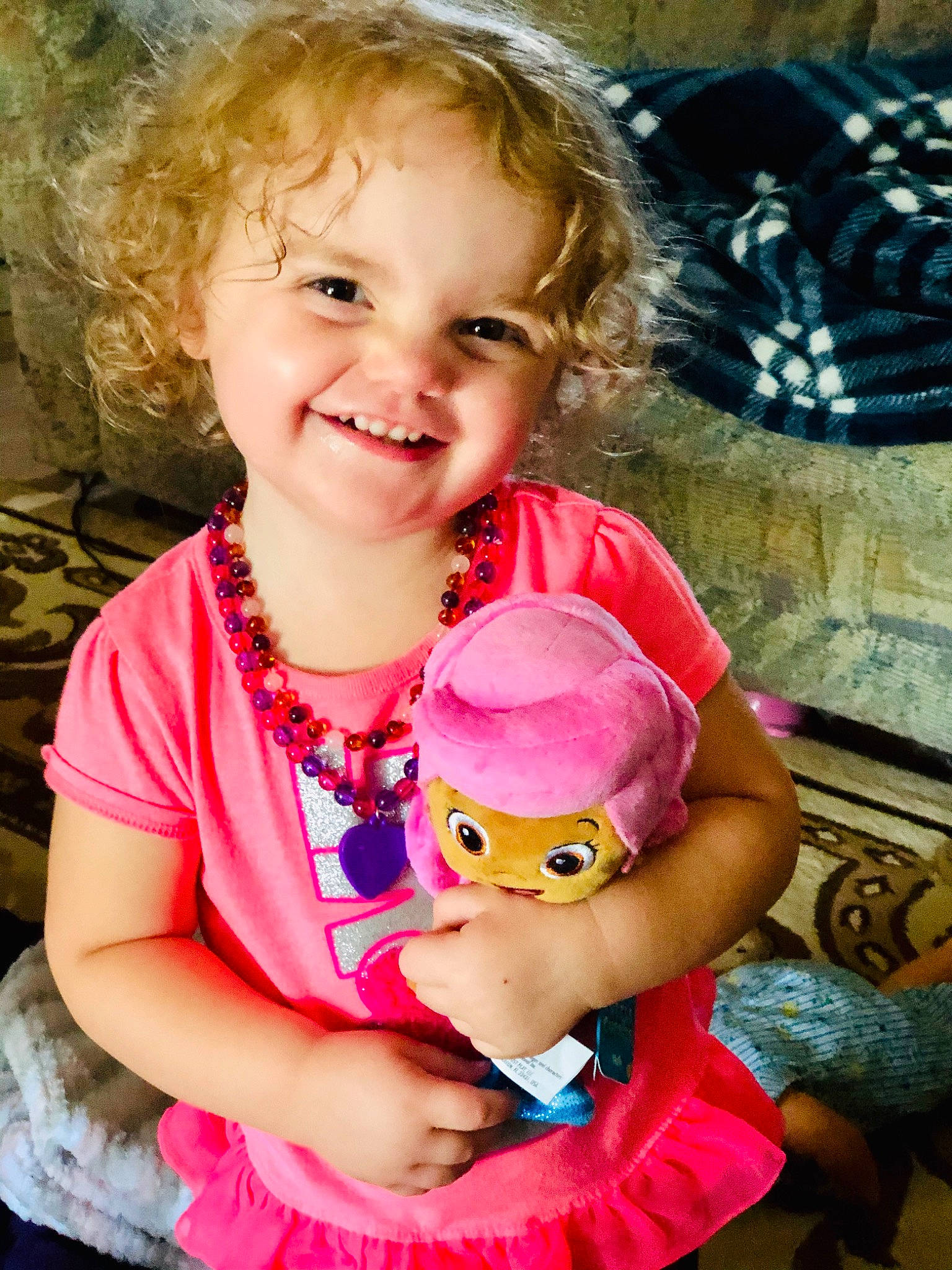 Autumn is registered to the contest to win money with this photo: baby, blond, brown_hair, cheek, child, child_model, ear, eye, face, fun, happy, head, joy, lip, person, pink, play, skin, smile, stuffed_toy