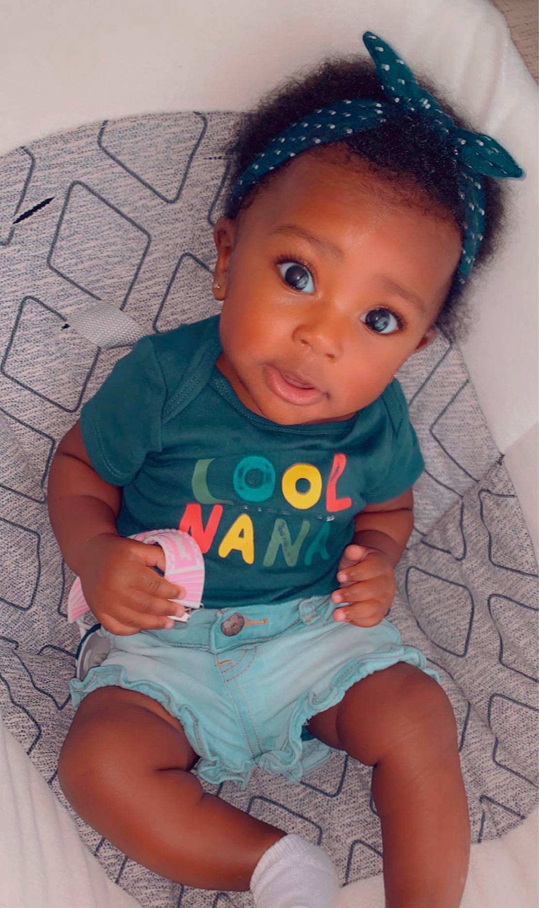 Halo is registered to the contest to win money with this photo: baby, baby_toddler_clothing, cheek, child, eye, forehead, hair_accessory, headband, iris, lip, person, sitting, skin, toddler