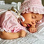 Sophia is registered to the contest to win money with this photo: baby, sleeping, pink_clothing, bonnet, infant, peaceful, soft_blanket, closeup, cute, child, resting, portrait, delicate, adorable, young, hands, face, skin, cozy, indoors
