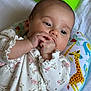 Sophia joined the competition — help win amazing prizes! baby, infant, child, onesie, floral_pattern, hand, fingers, pillow, giraffe, animal_print, bed, blanket, soft_light, portrait, cute, young_child, sleeping_area, peaceful, indoors, clothing