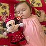 Emma joined the competition — help win amazing prizes! baby, sleeping, pink_dress, plush_toy, minnie_mouse, quilt, blanket, child, cuddling, soft_toy, peaceful, indoor, cute, adorable, resting, fabric, pattern, toy, infant, face