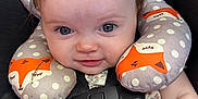 Emma is registered to the contest to win money with this photo: baby, child, car_seat, neck_pillow, fox_pattern, smile, blue_eyes, infant, seatbelt, clothing, cute, portrait, indoor, head_support, baby_toy, young_child, polka_dots, soft_toys, happy, closeup