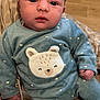 Islem participe au concours pour gagner de l'argent avec cette photo : baby, infant, child, blue_outfit, bear_patch, cushion, pattern, indoor, floor, skin, face, eyes, hand, clothing, sitting, cute, portrait, person, young, cozy