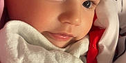 Tristán is registered to the contest to win money with this photo: baby, closeup, face, blanket, soft, curly_hair, eyelashes, skin, comfort, sleepy, infant, child, cute, warm, portrait, indoors, resting, peaceful, toddler, wrapped