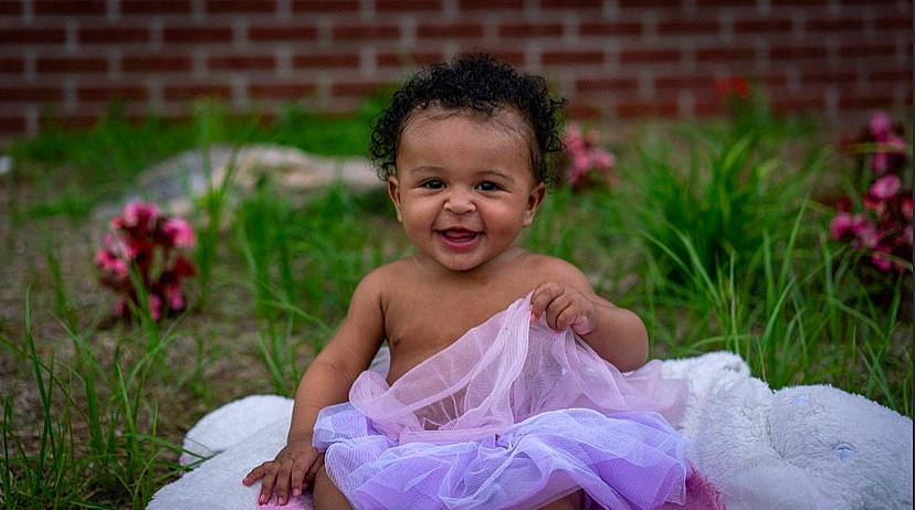 Ariyah joined the competition — help win amazing prizes! baby, baby_toddler_clothing, ballet_tutu, child, costume, dress, facial_expression, fun, grass, happy, joy, person, photography, pink, plant, sitting, skin, smile, toddler