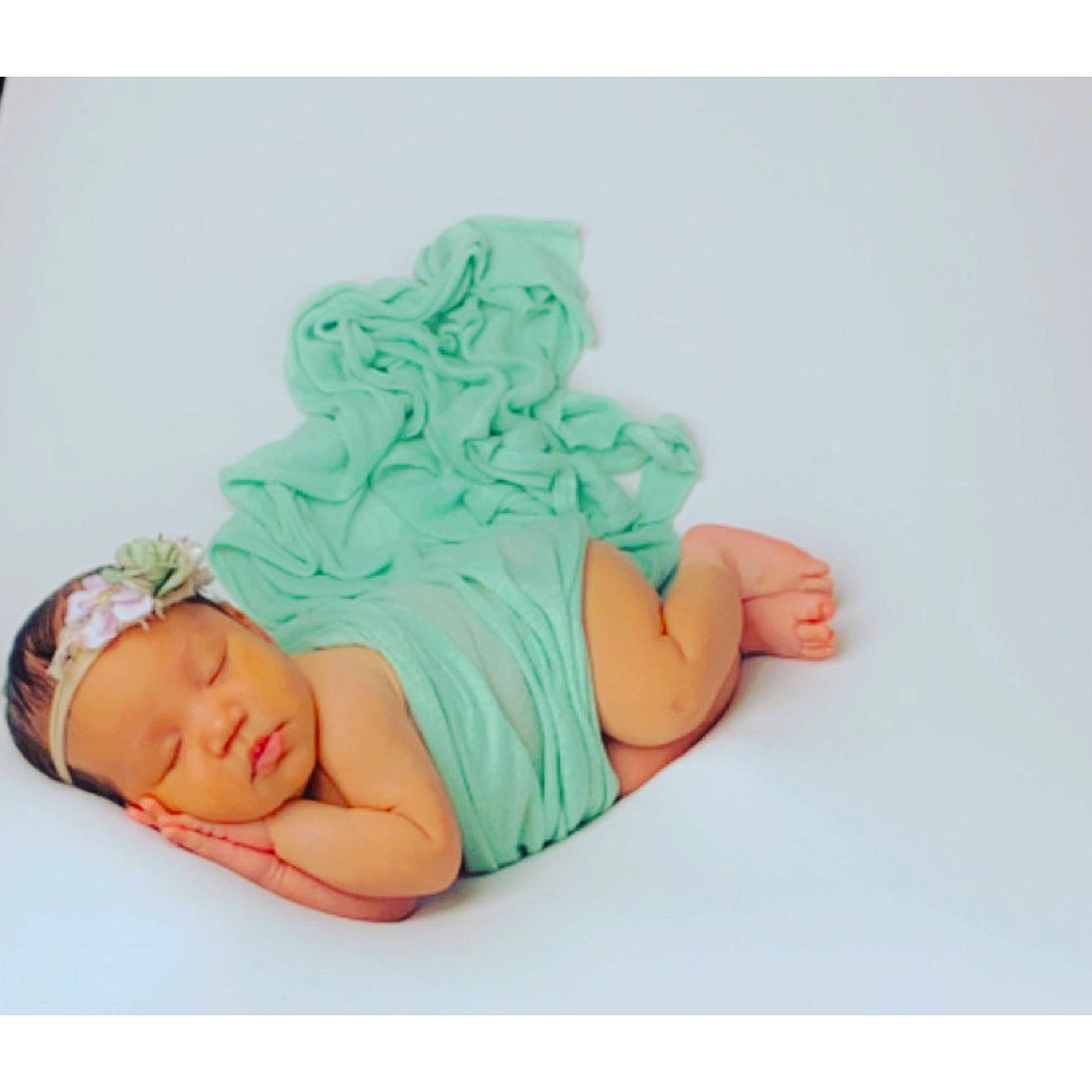 Nia is registered to the contest to win money with this photo: aqua, arm, baby, baby_products, baby_toddler_clothing, cap, clothing, comfort, font, foot, hand, hat, head, headgear, headwear, human_body, leg, linens, person, sleeve