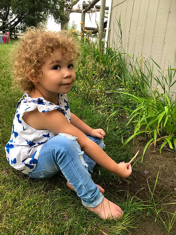 Azaliyah joined the competition — help win amazing prizes! baby_toddler_clothing, blond, garden, grass, grass_family, grassland, happy, human_leg, jeans, lawn, leisure, people_in_nature, person, plant, shoe, shrub, soil, t_shirt, terrestrial_plant, toddler