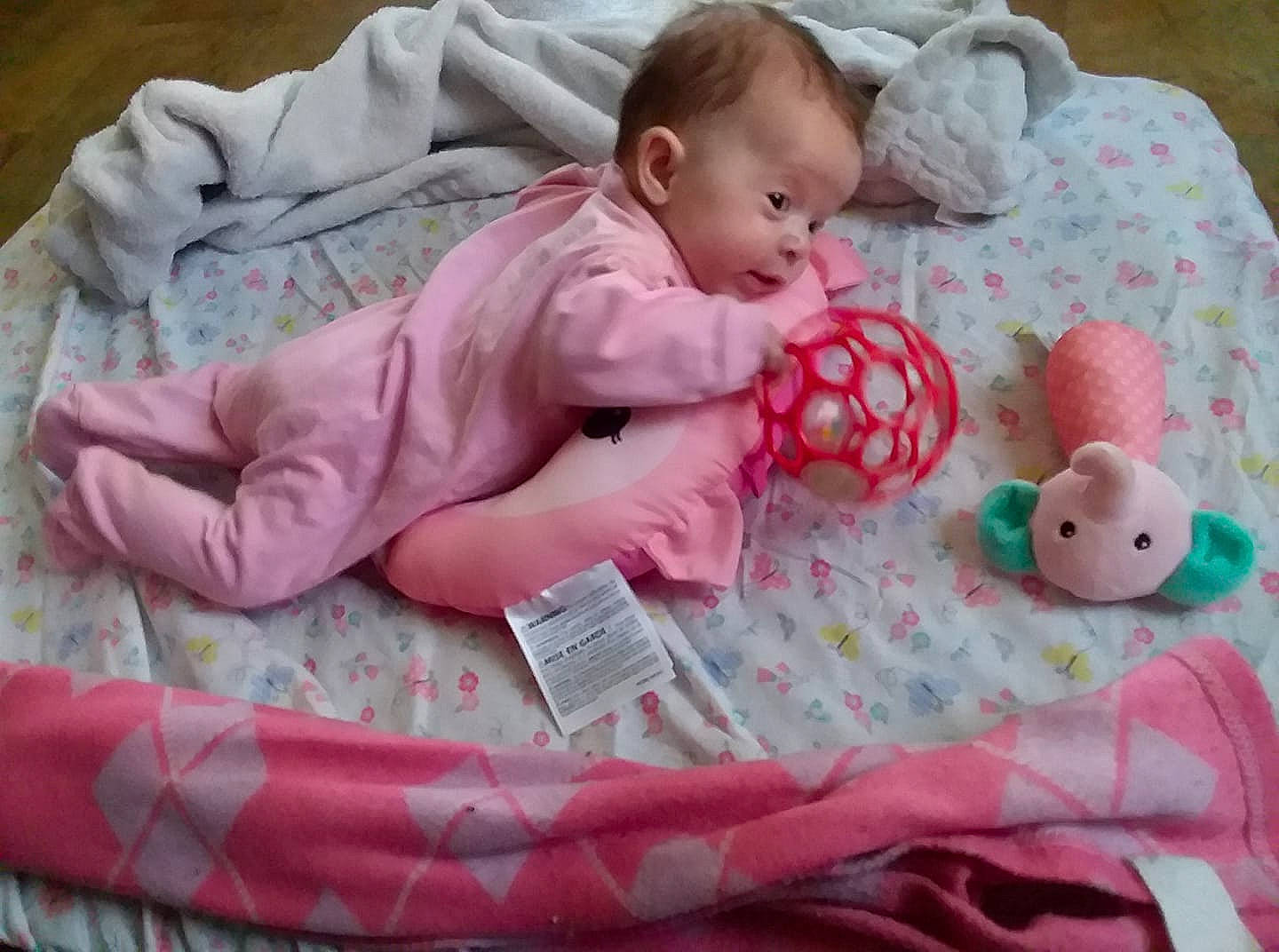 Iszabella is registered to the contest to win money with this photo: baby, baby_products, baby_safety, baby_toys, bedtime, blanket, child, infant_bed, linens, nap_mat, person, pink, play, product, textile, toddler