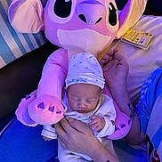 Néllya participe au concours pour gagner de l'argent avec cette photo : baby, newborn, plush_toy, purple, sleeping, hat, pajamas, tattoo, hand, cuddle, soft_toy, indoor, blanket, child, cute, peaceful, resting, person, comfort, cozy