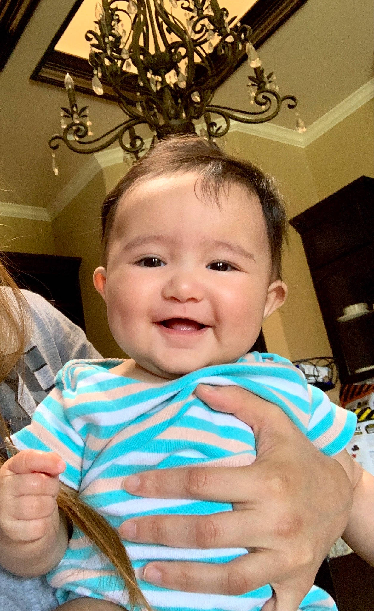 Macy is registered to the contest to win money with this photo: baby, baby_toddler_clothing, blue, cheek, child, chin, event, eyebrow, facial_expression, finger, fun, gesture, hand, happy, joy, mouth, ornament, person, skin, smile