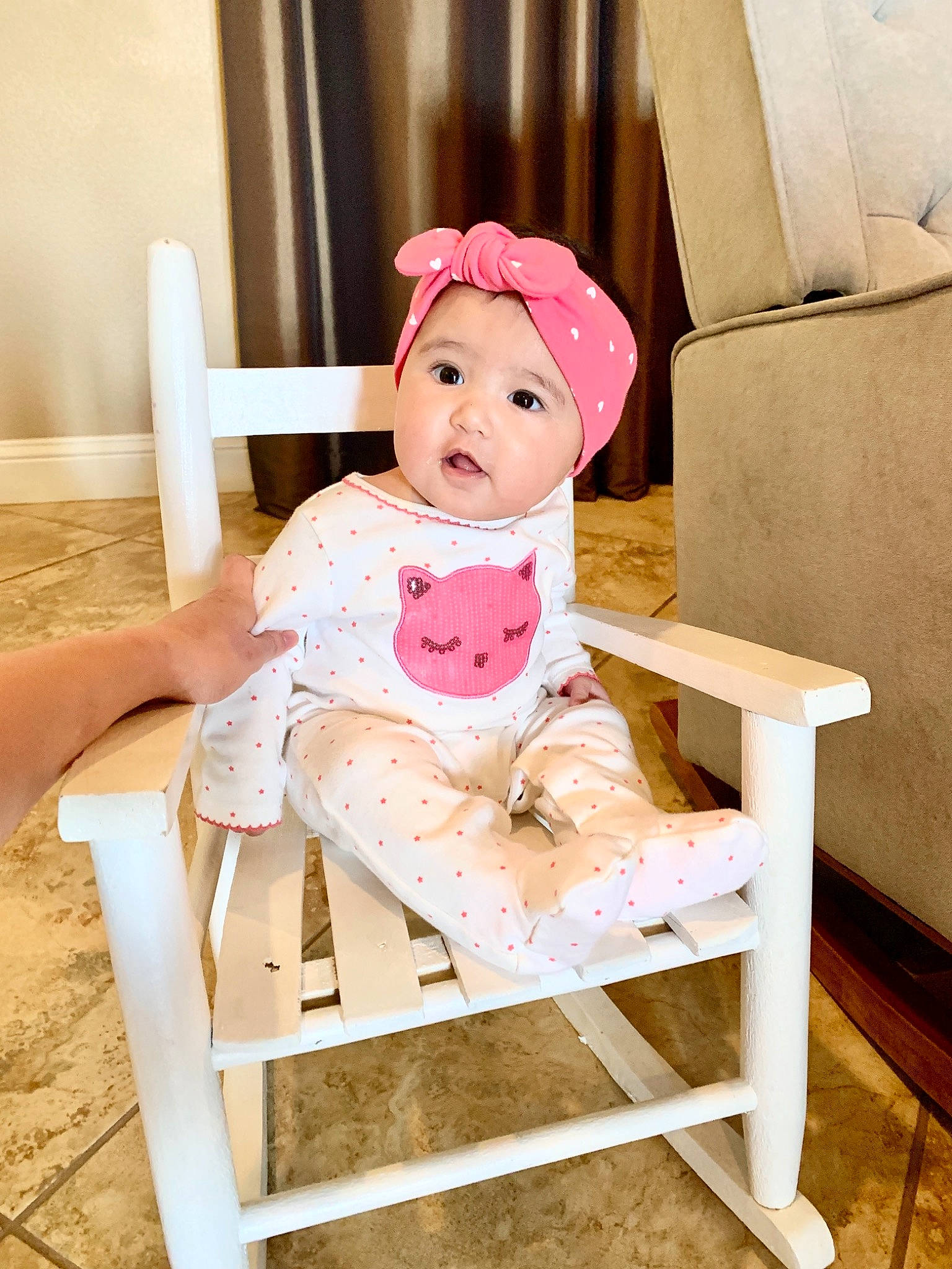 Macy joined the competition — help win amazing prizes! baby, baby_toddler_clothing, cap, chair, comfort, fedora, furniture, happy, headwear, human_body, human_leg, knee, leg, magenta, outdoor_furniture, person, pink, sitting, table, thigh