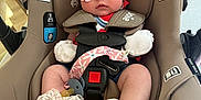 Paisleigh is registered to the contest to win money with this photo: baby, car_seat, sunglasses, headband, bow, infant, seatbelt, clothing, footwear, pacifier, lace, indoor, person, child, cute, accessory, seat, safety, baby_shoes, fashion