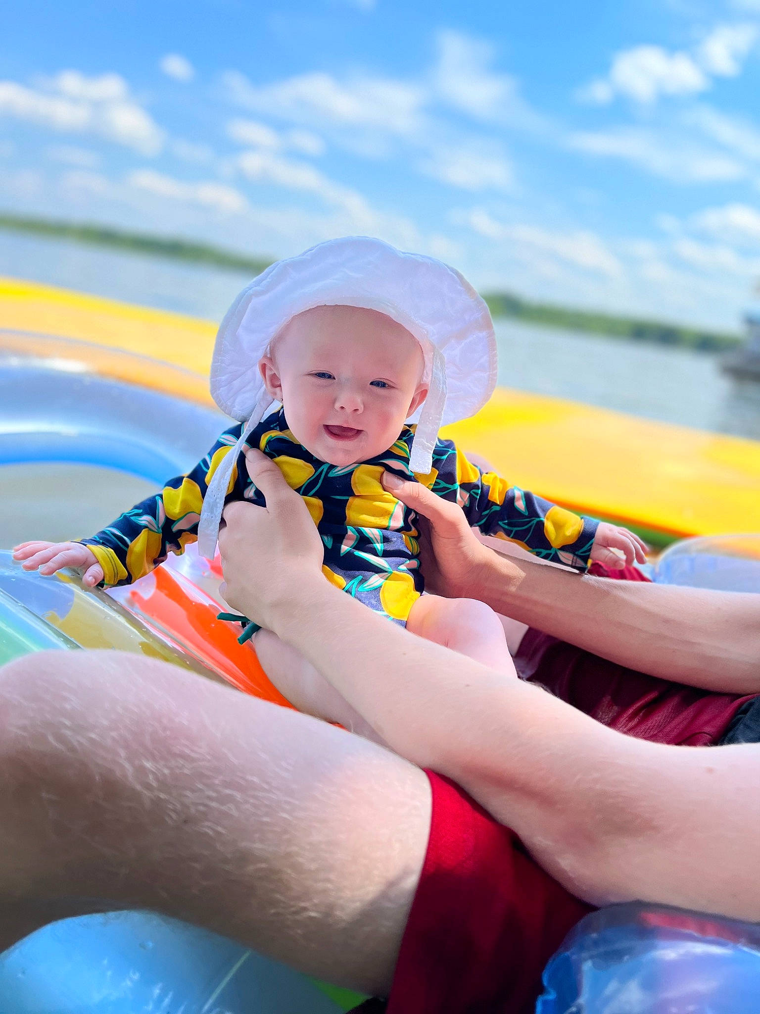 Brinlee is registered to the contest to win money with this photo: aqua, baby, baby_toddler_clothing, blue, boats_and_boating_equipment_and_supplies, body_of_water, cloud, finger, fun, happy, headgear, headwear, leisure, outdoor_recreation, person, personal_protective_equipment, product, recreation, sky, thigh