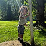 Kaylani joined the competition — help win amazing prizes! backyard, child, curly_hair, daylight, exploring, grass, greenery, nature, outdoor, pole, portrait, shoes, shorts, socks, standing, summer, sunlight, toddler, tree, young_child