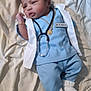 baby, infant, doctor_costume, stethoscope, blue_clothing, white_coat, bracelet, necklace, footwear, lying_down, bed, blanket, cute, portrait, young_child, indoors, person, medical, newborn, soft_lighting