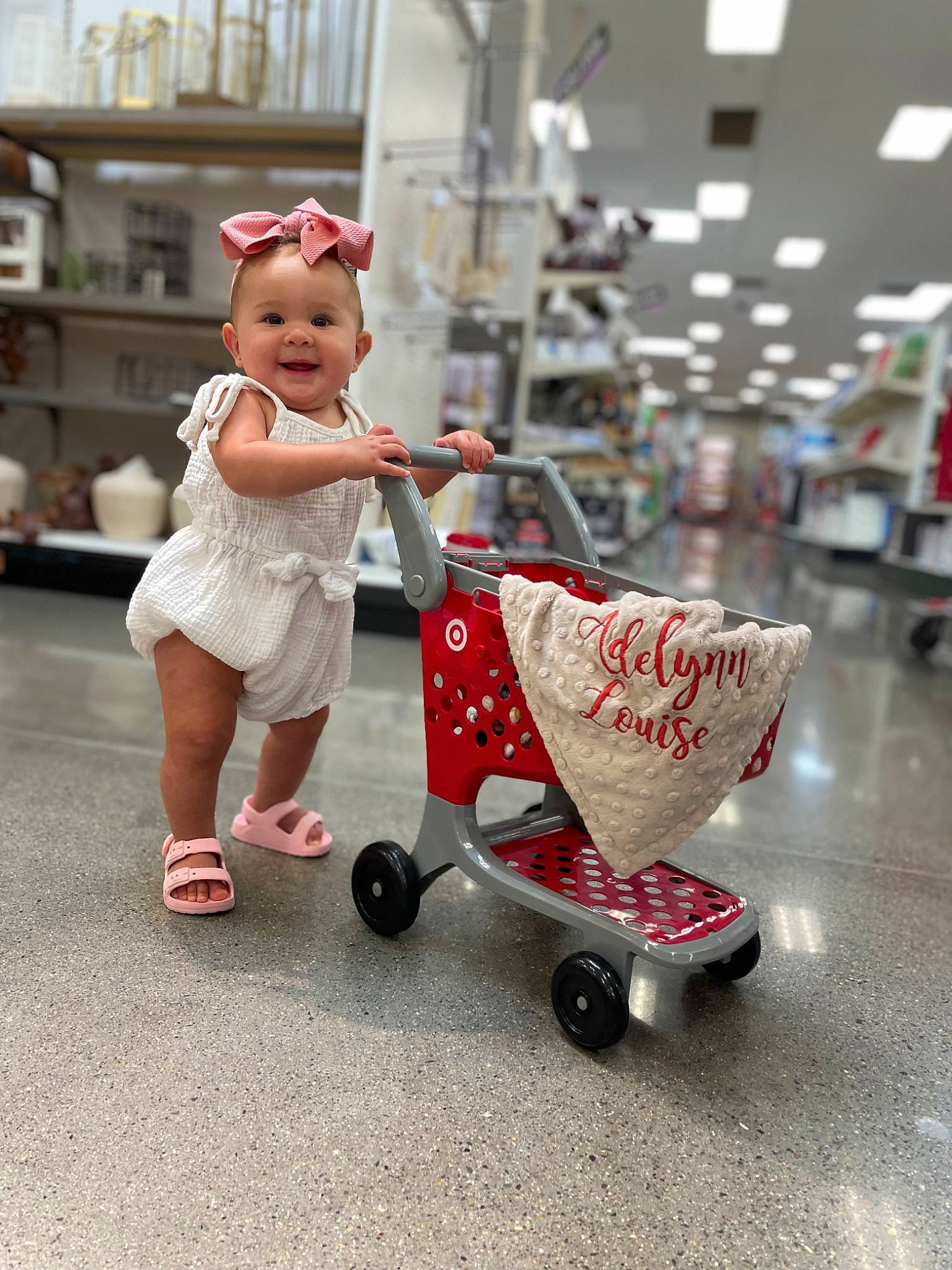 Adelynn joined the competition — help win amazing prizes! automotive_wheel_system, baby, baby_carriage, baby_products, baby_toddler_clothing, cart, child, event, flooring, fun, happy, hat, joy, person, recreation, rolling, sandal, shelf, shopping_cart, tire