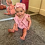baby, pink_outfit, headband, bow, carpet, mirror, reflection, smiling, indoor, child, cute, sitting, floor, person, infant, happy, playful, home, portrait, young_child