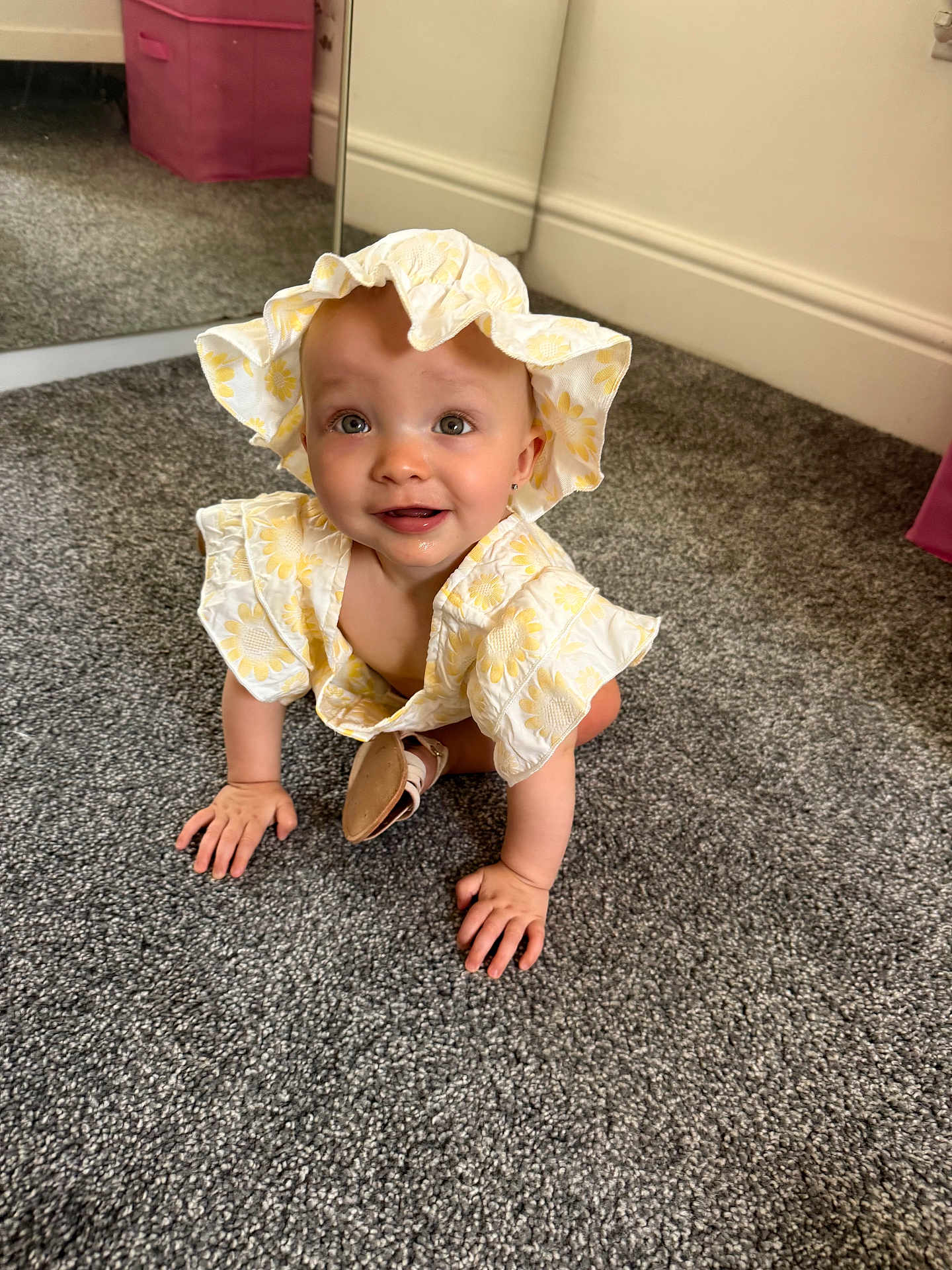 Arabella joined the competition — help win amazing prizes! baby, child, crawling, hat, yellow_flower, carpet, indoor, mirror, pink_box, happy, cute, smiling, clothing, person, headwear, floor, curious, infant, room, earrings
