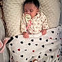 Mïa participe au concours pour gagner de l'argent avec cette photo : baby, newborn, sleeping, pacifier, blanket, heart_pattern, floral_pajamas, bassinet, pillow, plush, peaceful, infant, swaddle, nursery, hands, cozy, soft_texture, sleepwear, closeup, portrait