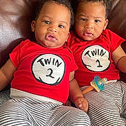 Zamir Jahziel joined the competition — help win amazing prizes! twin, baby, toddler, red_shirt, striped_pants, pacifier, leather_couch, sitting, indoor, child, cute, matching_clothes, siblings, infant, person, face, expression, curious, close, bonding