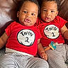 baby, bonding, child, close, curious, cute, expression, face, indoor, infant, leather_couch, matching_clothes, pacifier, person, red_shirt, siblings, sitting, striped_pants, toddler, twin