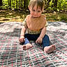Judson joined the competition — help win amazing prizes! baby, child, outdoor, forest, blanket, bib, sitting, nature, sunlight, trees, grass, cute, infant, greenery, young, portrait, casual_clothing, feet, expression, daylight