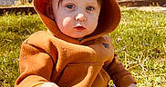 Judson joined the competition — help win amazing prizes! toddler, child, hoodie, orange, grass, outdoor, backyard, house, stairs, plastic_chair, sunlight, person, casual, curious, nature, daytime, young_child, sitting, clothing, play