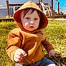 toddler, child, hoodie, orange, grass, outdoor, backyard, house, stairs, plastic_chair, sunlight, person, casual, curious, nature, daytime, young_child, sitting, clothing, play
