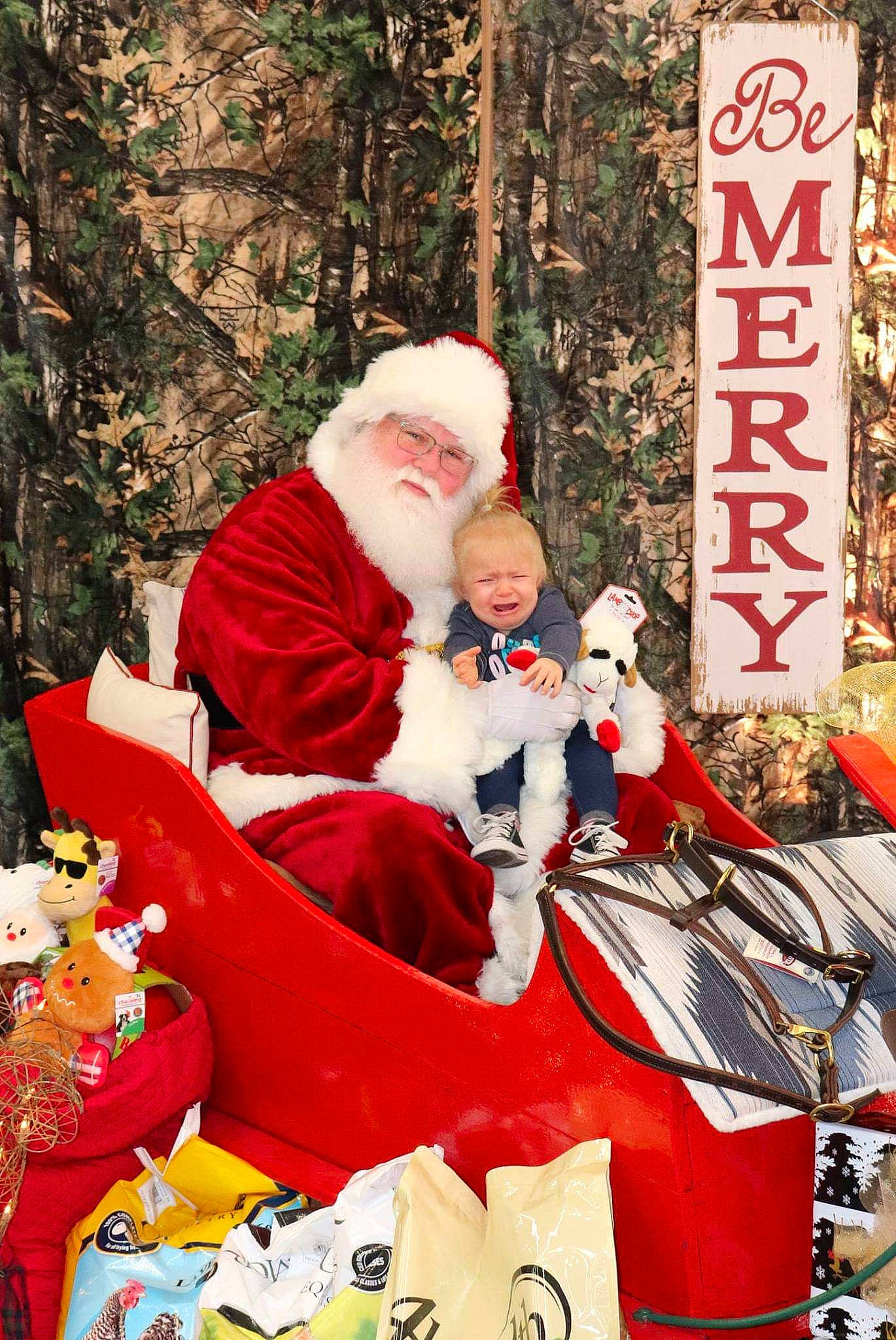 Khaleesia is registered to the contest to win money with this photo: christmas, christmas_decoration, event, fictional_character, fun, headwear, holiday, joy, lap, person, product, santa_claus, sorrow, tradition, tree, winter