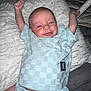 Monroe joined the competition — help win amazing prizes! baby, smiling, infant, child, clothing, pillow, blanket, indoor, person, cute, happy, stretching, apparel, fabric, soft, lying_down, relaxed, face, skin, head