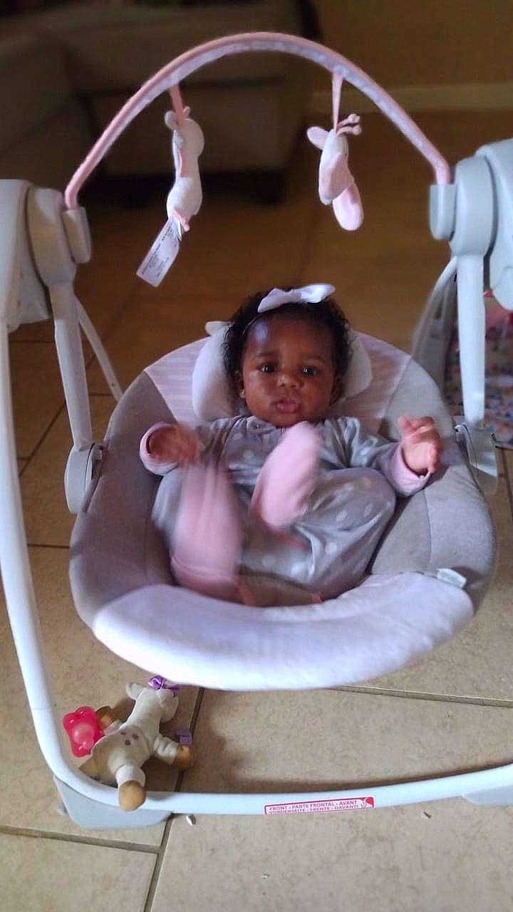 Nala Jai is registered to the contest to win money with this photo: baby, baby_products, baby_toddler_clothing, baby_toys, chair, child, circle, comfort, fashion_accessory, fun, happy, jewellery, magenta, mechanical_fan, metal, person, pink, sitting, table, toddler