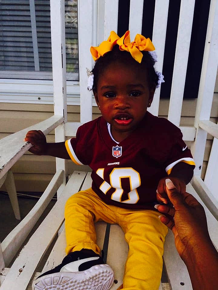 Dayla is registered to the contest to win money with this photo: baby_toddler_clothing, child, costume, headgear, jersey, person, plant, sportswear, t_shirt, toddler, vacation, yellow