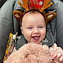 Rosalie-Marie joined the competition — help win amazing prizes! baby, blanket, car_seat, child, clothing, cozy, cute, face, hands, happy, headband, holiday_theme, indoors, infant, pacifier, portrait, reindeer_antlers, seatbelt, smiling, soft_texture