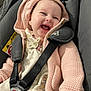 Rosalie-Marie is registered to the contest to win money with this photo: adorable, baby, car_seat, child, closeup, clothing, cute, face, happy, indoor, infant, knitwear, laughing, pacifier_clip, pink_hoodie, seatbelt, smile, straps, warm_clothing, young_child