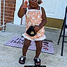 toddler, child, sunglasses, colorful_beads, romper, sandals, purse, porch, brick_wall, door, mat, chair, concrete, outdoor, fashion, cute, posing, summer, accessories, happy