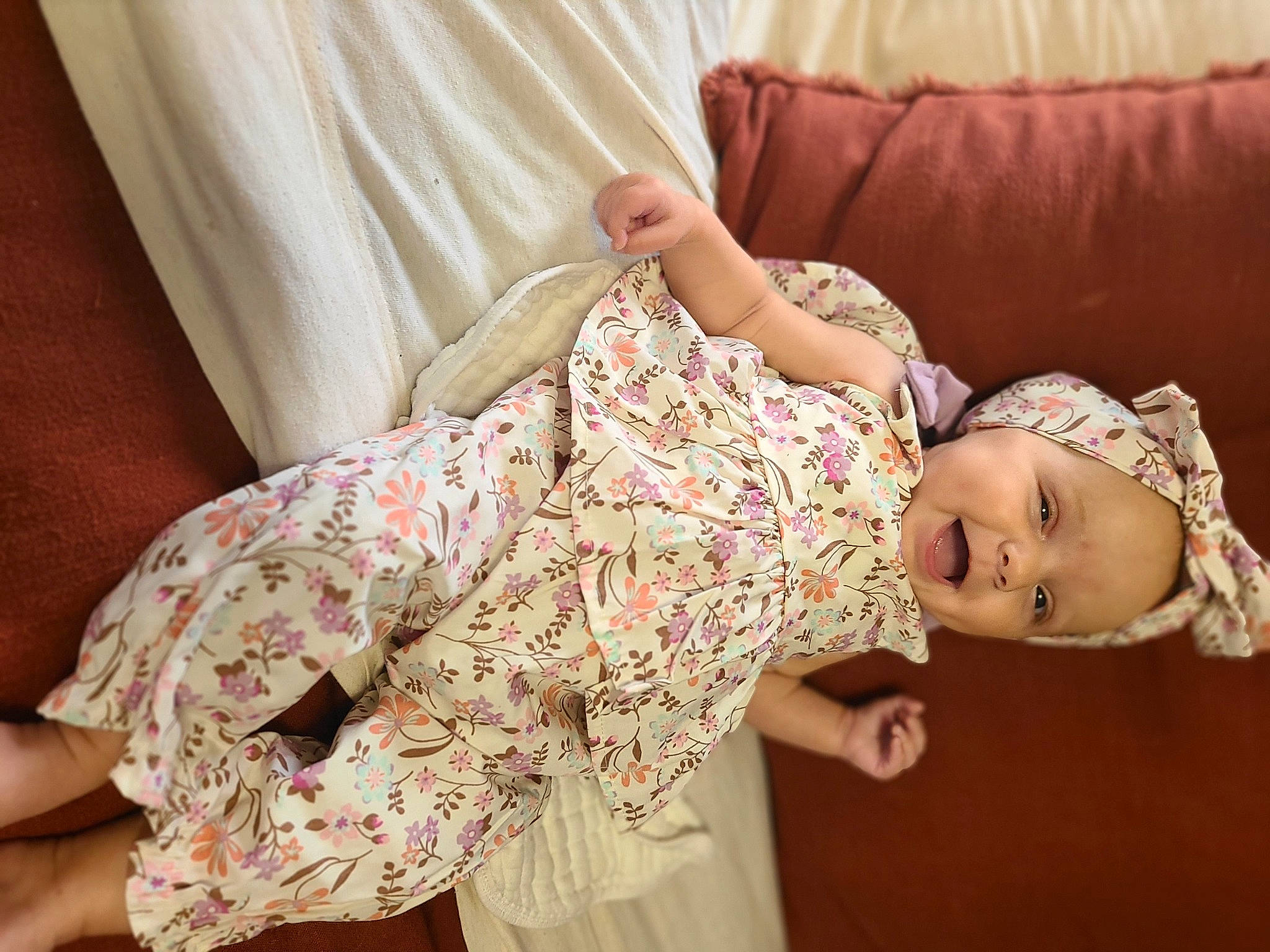 Margarett is registered to the contest to win money with this photo: arm, baby, baby_toddler_clothing, comfort, couch, eyelash, happy, head, headwear, human_body, joint, linens, neck, pattern, person, pink, shoulder, skin, sleeve, textile