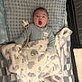 baby, infant, blanket, pacifier, yawning, animal_print, bedding, plush_toys, sleepwear, cute, child, indoors, resting, comfort, soft, blue, white, newborn, lying_down, peaceful