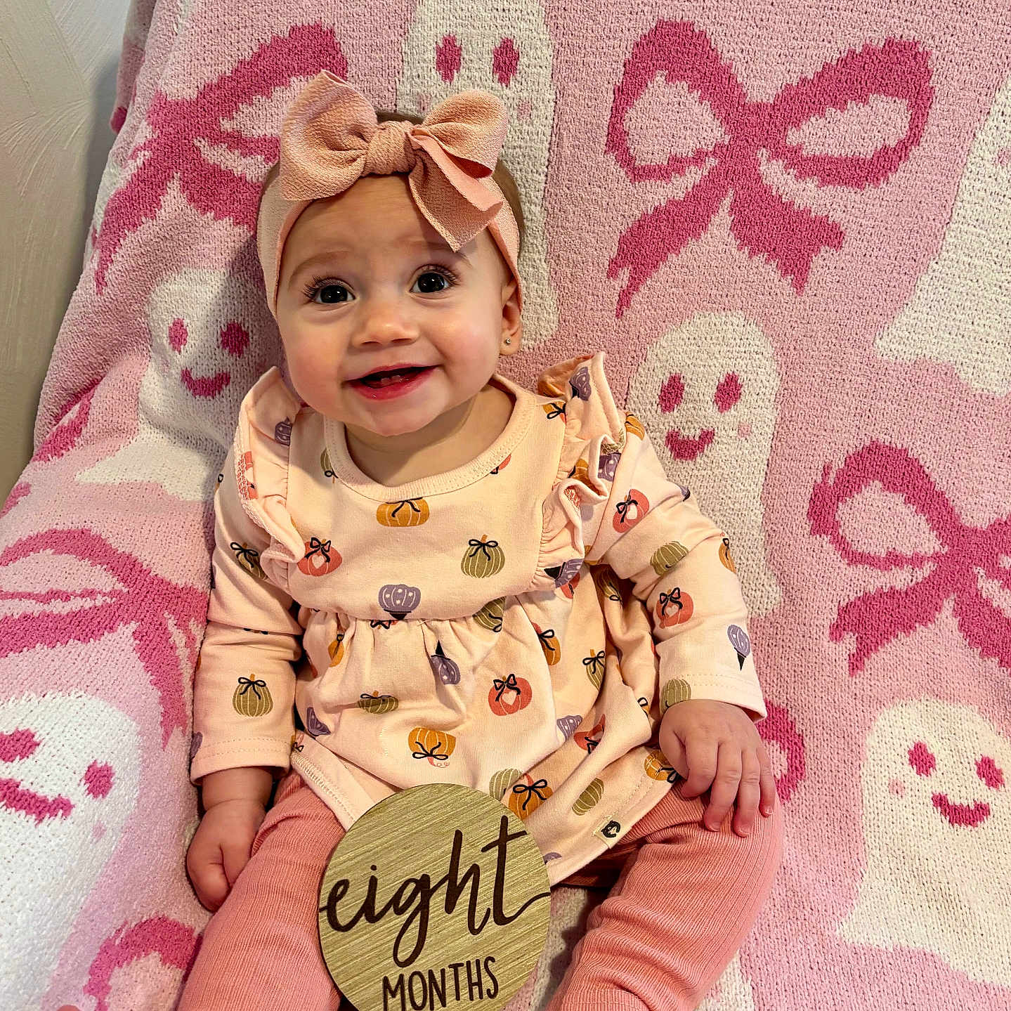 Cecilia joined the competition — help win amazing prizes! baby, blanket, bow, child, cute, dress, feet, ghost, hand, happy, headband, indoors, infant, months, pattern, pink, pumpkin, sitting, smile, wooden_sign